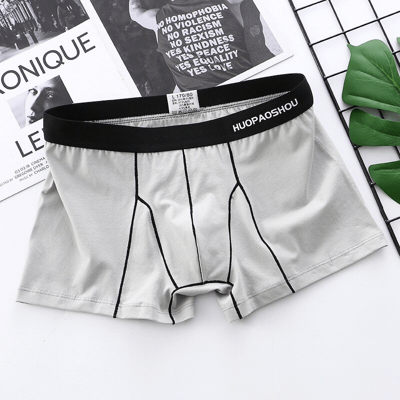 Elastic soft men's boxer briefs in gray with black waistband, featuring premium cotton fabric for comfort and breathability.